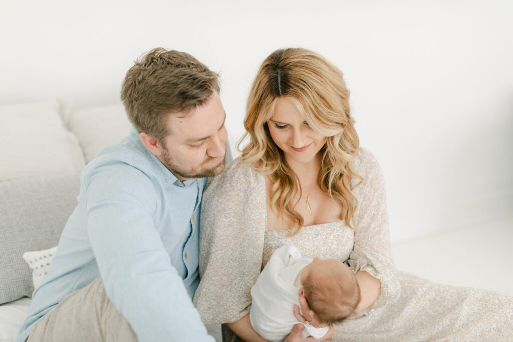 Man, woman, and newborn baby as an example of atlanta newborn session