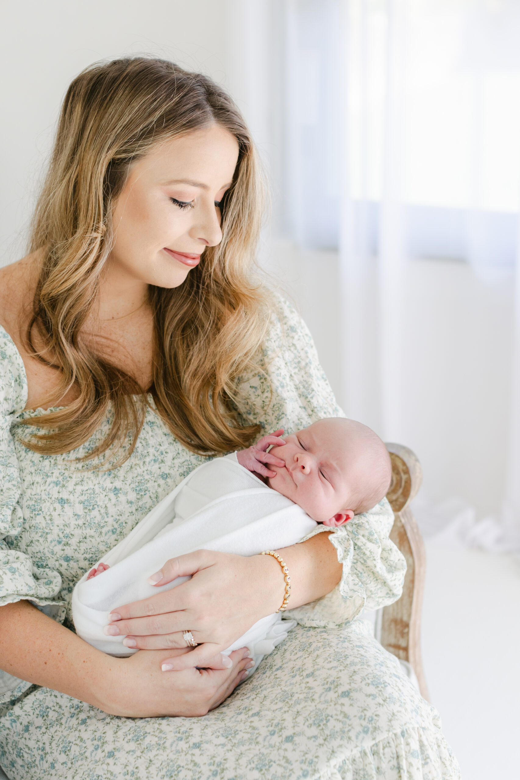 Woman holding newborn baby as an example of Pelvic Floor Physical therapists in Atlanta by Atlanta newborn photographer